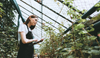 young-woman-gardener-in-glasses-and-apron-with-dig